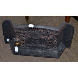A cast iron fire grate circa 1887 cast and pierced with a ship flanked by the royal supporters and