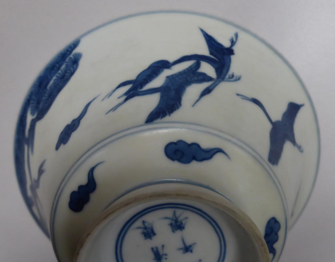 A Chinese porcelain bowl, decorated with four cranes flying amidst clouds and pine trees, bears - Image 7 of 7