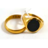 An 18ct gold bloodstone set signet ring, finger L1/2, and a 22ct gold band ring, finger size P (