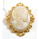 A 9ct gold opal cameo brooch/pendant, carved as a maiden, with a flower in her hair, in a scroll