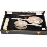 A four piece cased silver dressing table set  Appears in good condition.