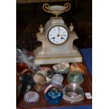 An alabaster striking mantel clock and a quantity of paperweights, 3-inch enamel dial, twin barrel