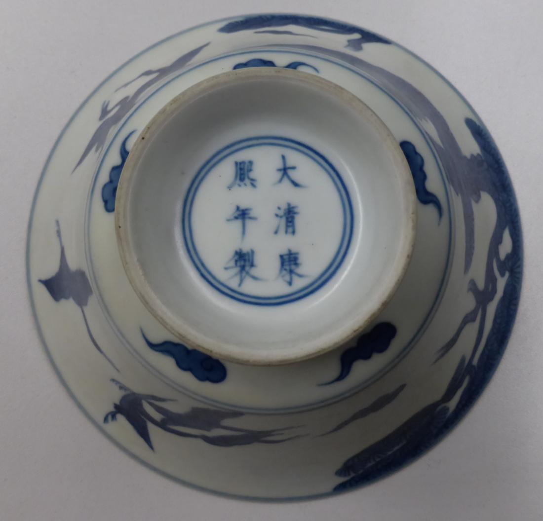 A Chinese porcelain bowl, decorated with four cranes flying amidst clouds and pine trees, bears - Image 4 of 7