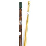 A horn swagger stick with gilt metal pommel; and a bamboo walking stick with jade finial and