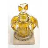 A Bohemian amber flashed scent bottle and stopper, circa 1880, modelled as a crown engraved with a