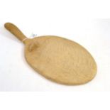 A Robert ''Mouseman'' Thompson oak cheese board, with carved mouse on the board, 37cm Good condition