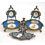 A champleve watch stand, 13cm high, and a pair of Sevres-style watch stands, 16cm high Damage