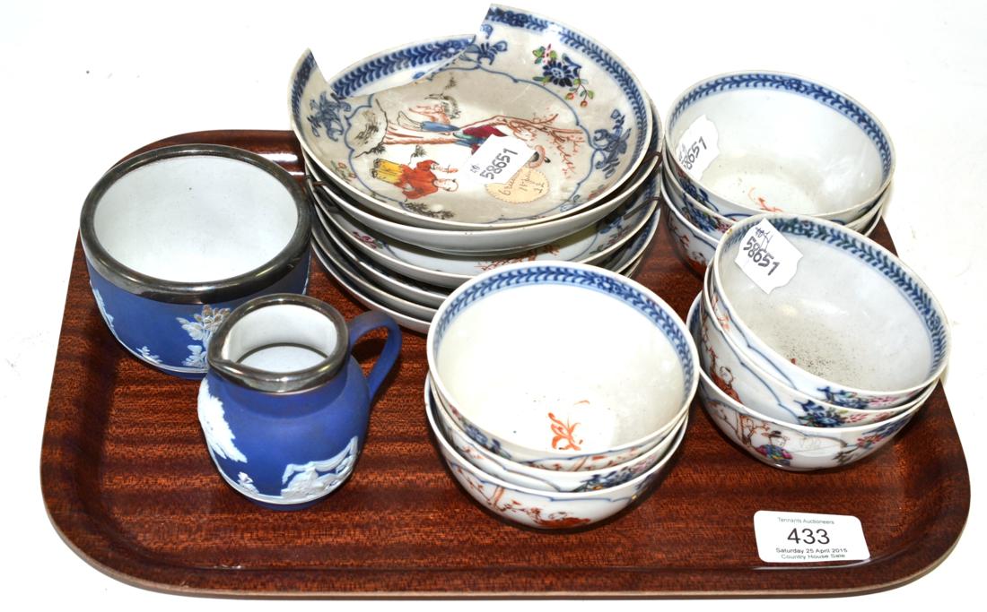 A set of nine Chinese porcelain tea bowls and six saucers, painted in famille rose enamels with