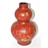 A Chinese red lacquer double gourd vase painted in gilt with figures in landscapes, bears four