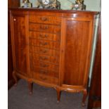 A mahogany D-shaped cabinet with two cupboard doors, the centre section fitted with nine drawers for