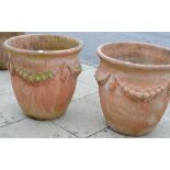 Pair of large terracotta planters decorated with swags, 69cm diameter