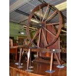An early 19th century spinning wheel on square chamfered legs and an early 19th century oak stool on