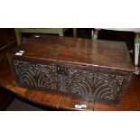 A 17th century oak bible box with carved panel to the front