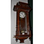 A Vienna type striking wall clock, circa 1900, glazed front and side panels, applied wooden