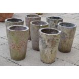 Set of seven terracotta cylindrical planters, 52cm high