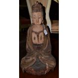 A 14th century style carved wooden figure of Bodhisattva seated on a stylised mountain, with