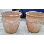 Pair of large terracotta planters decorated with swags, 69cm diameter