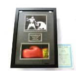 A Signed Muhammad Ali Boxing Glove Montage, comprising a glove, photograph and quotation, in an
