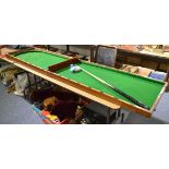 ''Bagatelle'' folding mahogany billiards table, including balls and side peg score system