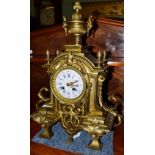 A gilt metal striking mantel clock, circa 1890, case with scroll mounts and acorn finials, 4-inch