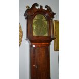 An oak eight day longcase clock, swan neck pediment, 12-inch arched brass dial, plaque bearing