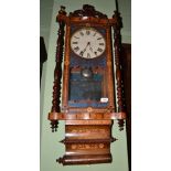 An inlaid striking wall clock, circa 1890, turned side columns, elaborately decorated with boxwood