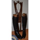 A pair of leather riding boots and trees; and a boot jack