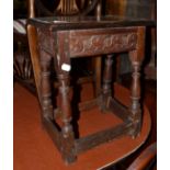 A 17th century oak joint stool with carved frieze