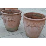 Pair of large terracotta planters decorated with vines and fruit, 65cm diameter