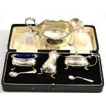 Cased three piece silver cruet and George III style silver sauce boat (2)