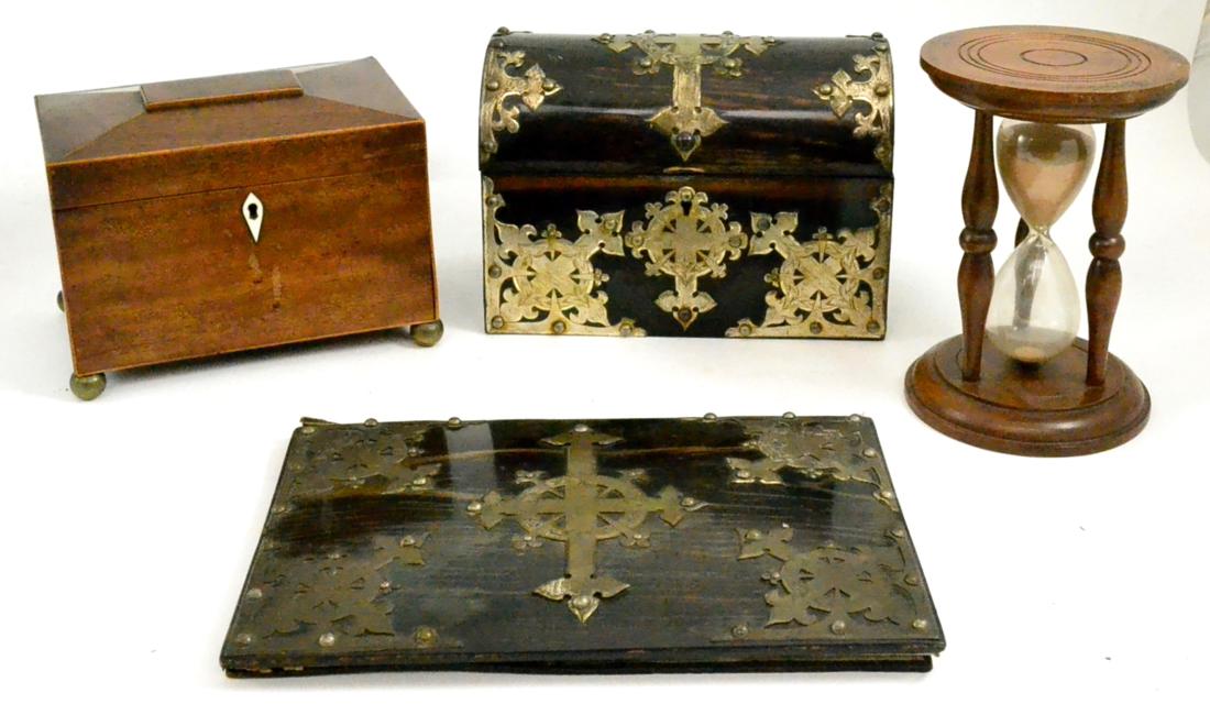 An ebony veneered stationary box and a blotting pad with applied metal mounts, egg timer, tea caddy