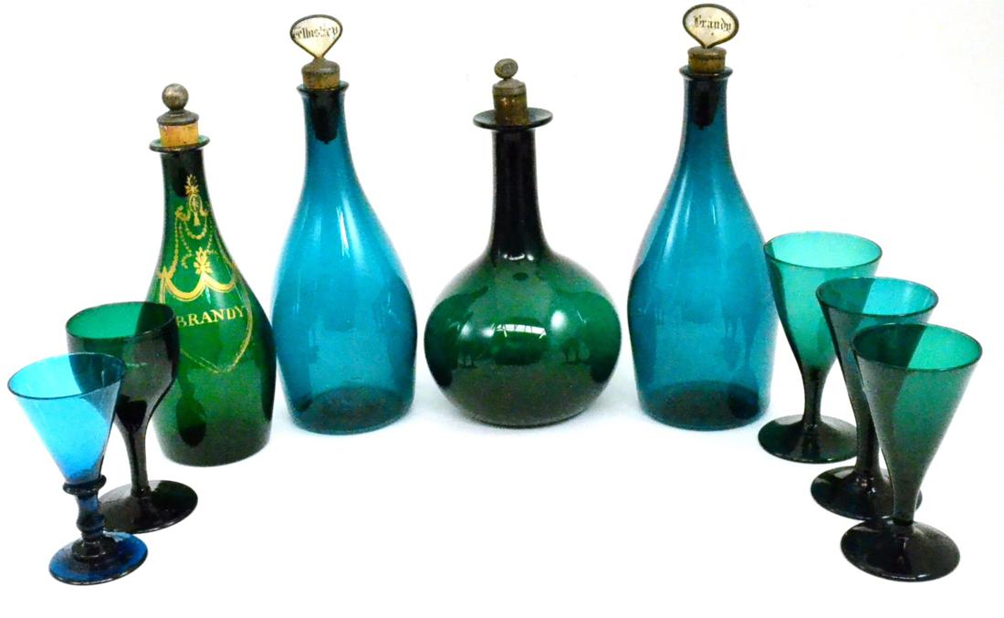 A tray of green glass including spirit decanters with stoppers and wine glasses