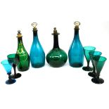 A tray of green glass including spirit decanters with stoppers and wine glasses