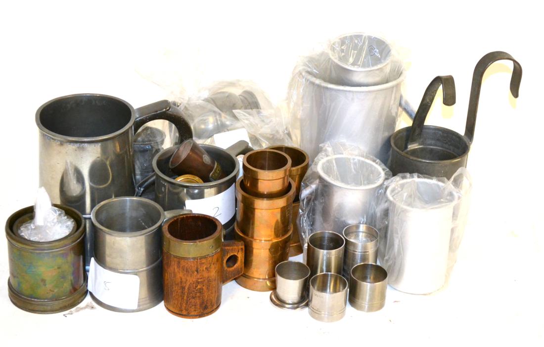 A Collection of Pewter, Brass and Other Measures, including eleven brass capacity measures, set of