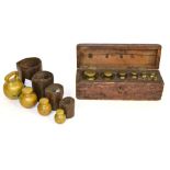 A Cased Part Set of Nine Spherical Brass Weights, sizes from 4lb to 1/4oz (one missing), in a fitted