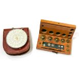 Fowler's Universal Calculator in leather case, together with a set of Weights from 50g in wooden