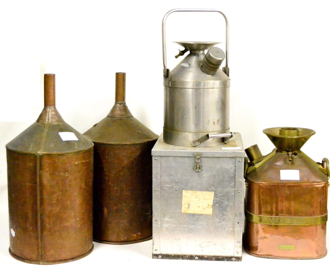 Three Petrol Measures, comprising a 5 gallon copper and brass measure, and two 10 litre stainless