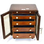 A Small Mahogany Chest of Drawers, with five graduated ivory handled drawers, under glazed doors,