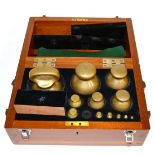 A Cased Part Set of Twelve Avery Spherical Brass Weights, from 7lb to 1/2dr (missing 1oz weight), in