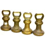 A Set of Four Avery 56lb Brass Bell Weights