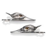 A Pair of Silver Plated Novelty Paper Clips, in the form of a duck's head with glass eyes, 13cm long
