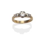 A Diamond Ring, a round brilliant cut diamond in white claw settings, with a baguette cut diamond on