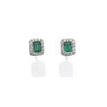 A Pair of 18 Carat White Gold Emerald and Diamond Cluster Earrings, the emerald-cut emerald within a