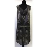 Circa 1920s Black Sleeveless Shift Dress with v neck and silver bead decoration overall