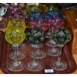 A set of twelve cut crystal hock glasses with facet stems and coloured bowls