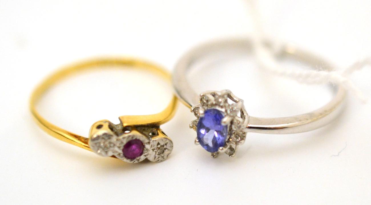 A tanzanite and diamond cluster ring, stamped 'PT 950' and a ruby and diamond three stone twist ring