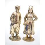 A pair of 19th century Continental white metal pepperettes, modelled as a Dutch boy and girl in