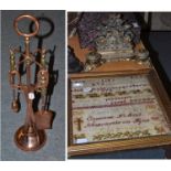 A sampler worked by Annie M ?, convent school, Newcastle upon Tyne, June 5 1882, a brass inkstand