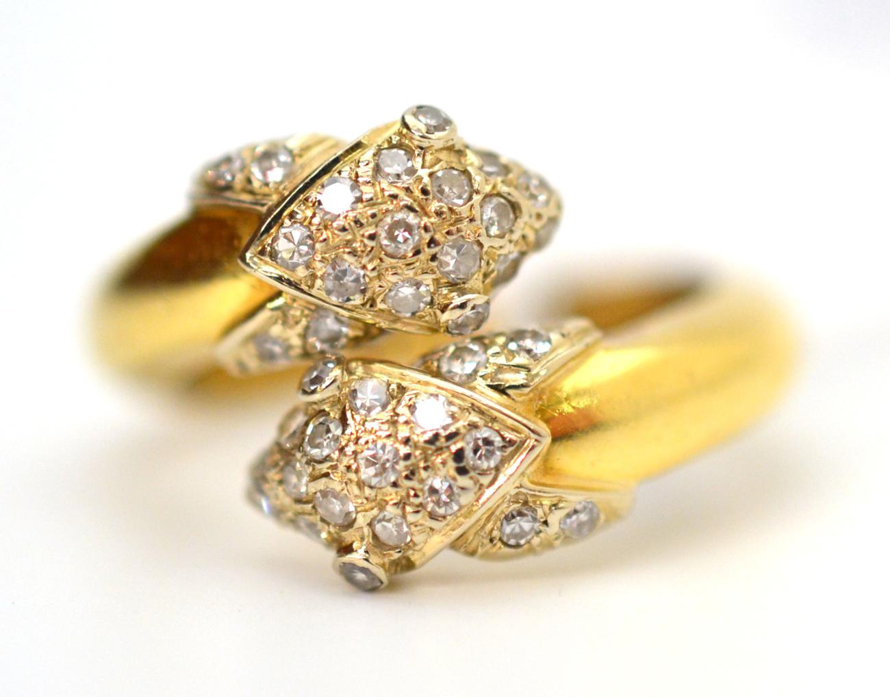 A diamond set crossover ring, each pointed diamond section pavé set with eight-cut diamonds, to a