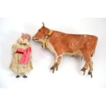 Late 19th century German cow figure with moving head (stand missing) and a bisque dolls house